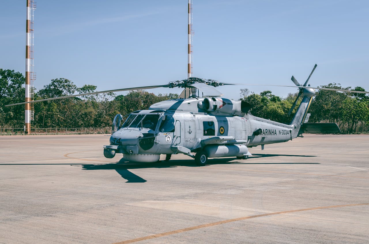 creative Military helicopter stationed at Brasília airstrip with clear blue sky background.